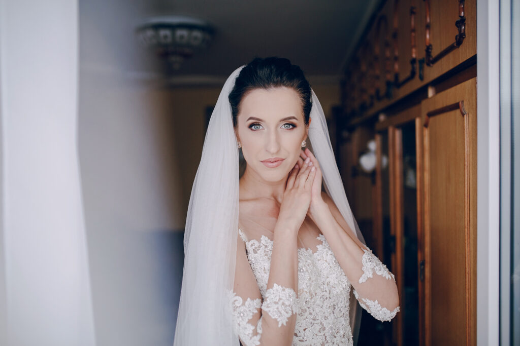 bride in a white dress standing in the room