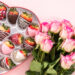 A plate of homemade chocolate-covered strawberries drizzled with white chocolate, perfect for Valentine’s Day