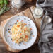 Plate with delicious risotto on wooden table