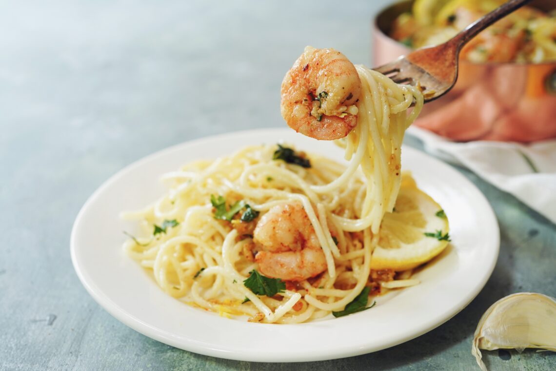 Homecooked Shrimp Scampi with Spaghetti pasta and lemon, selective focus