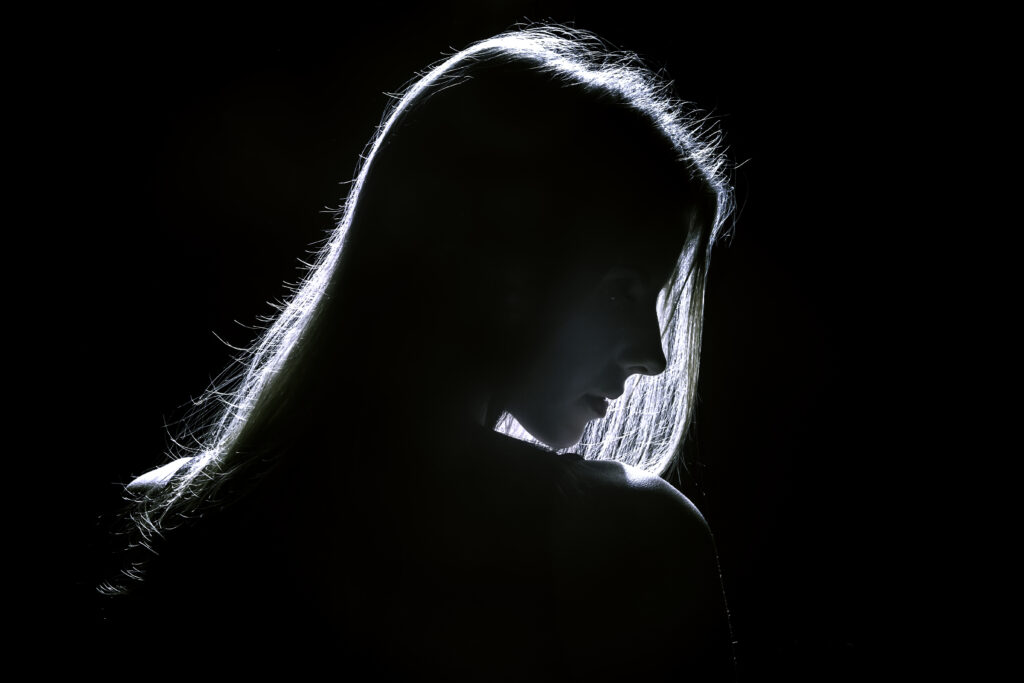 sad woman profile silhouette in dark