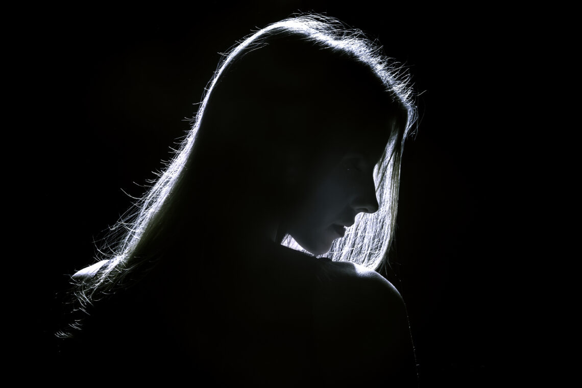 sad woman profile silhouette in dark